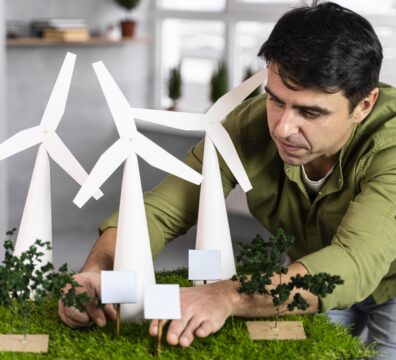 The Rise of Renewable Energy Diplomacy: How Nations Are Collaborating to Accelerate the Clean Energy Transition Front View Man Working Eco Friendly Wind Power Project With Wind Turbines 396x360